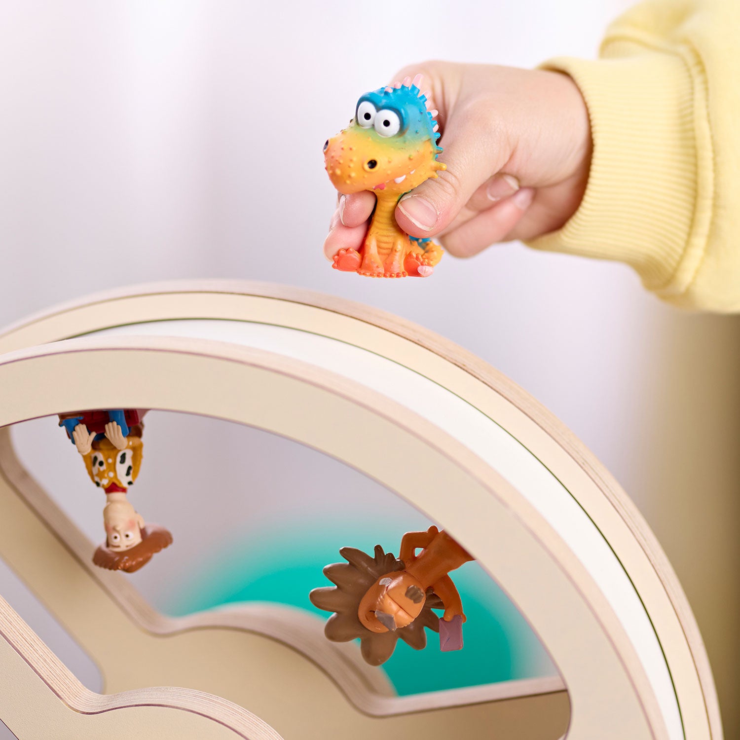 Eine tonie-Figur wird von Kinderhand auf das magnetische Rad gesetzt